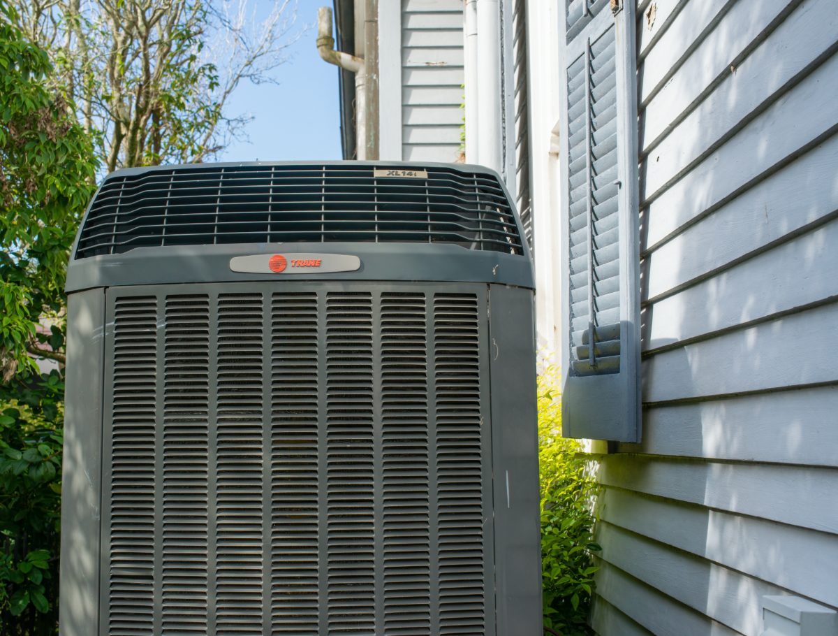 Trane residential air conditioning unit installed beside a home